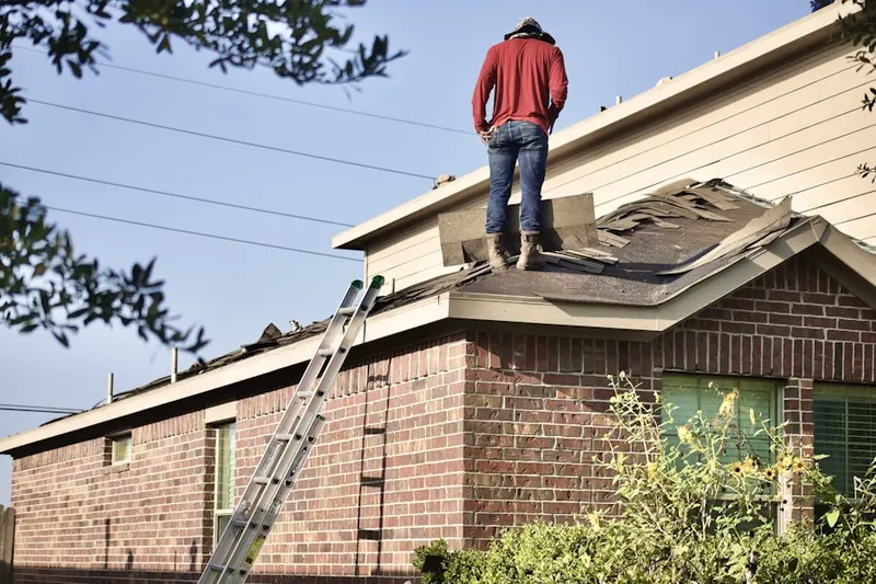 Professional roofer working on a residential roof in Big Bear Lake